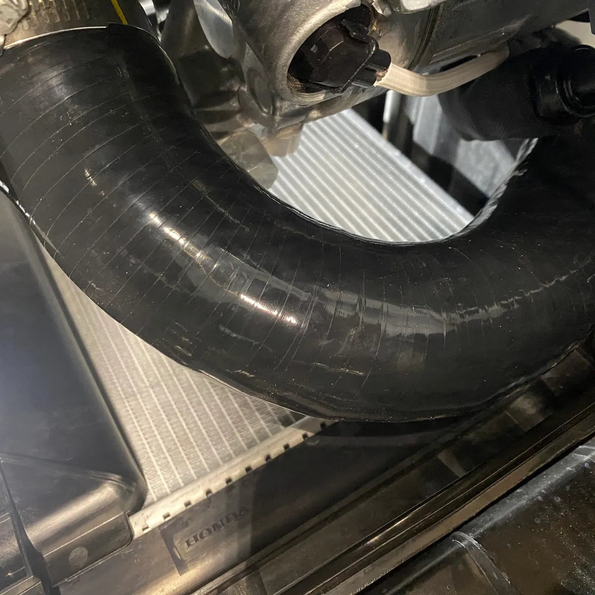 Close-up of silicone intercooler hose routing inside Civic Type R engine bay